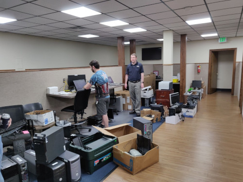 Two BTS workers working on donated computers, so they can be donated to charity
