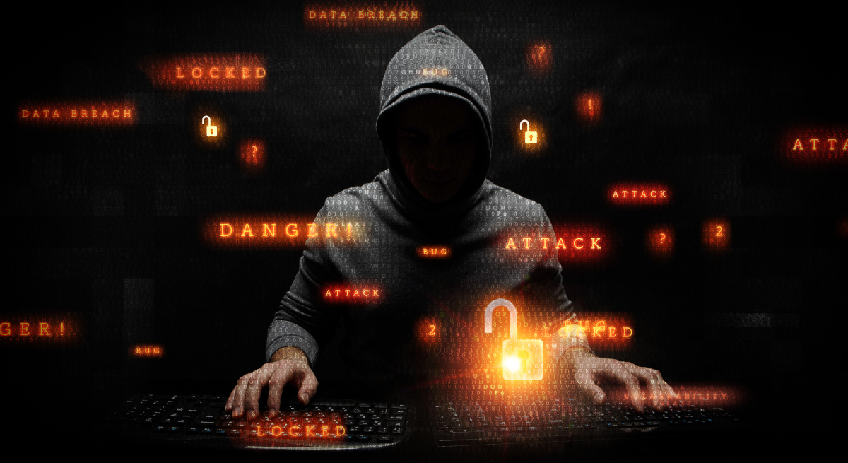 A hacker in a dark hoodie overlaid with orange words: 'danger', 'attack', 'breach', 'data', and 'locked'.