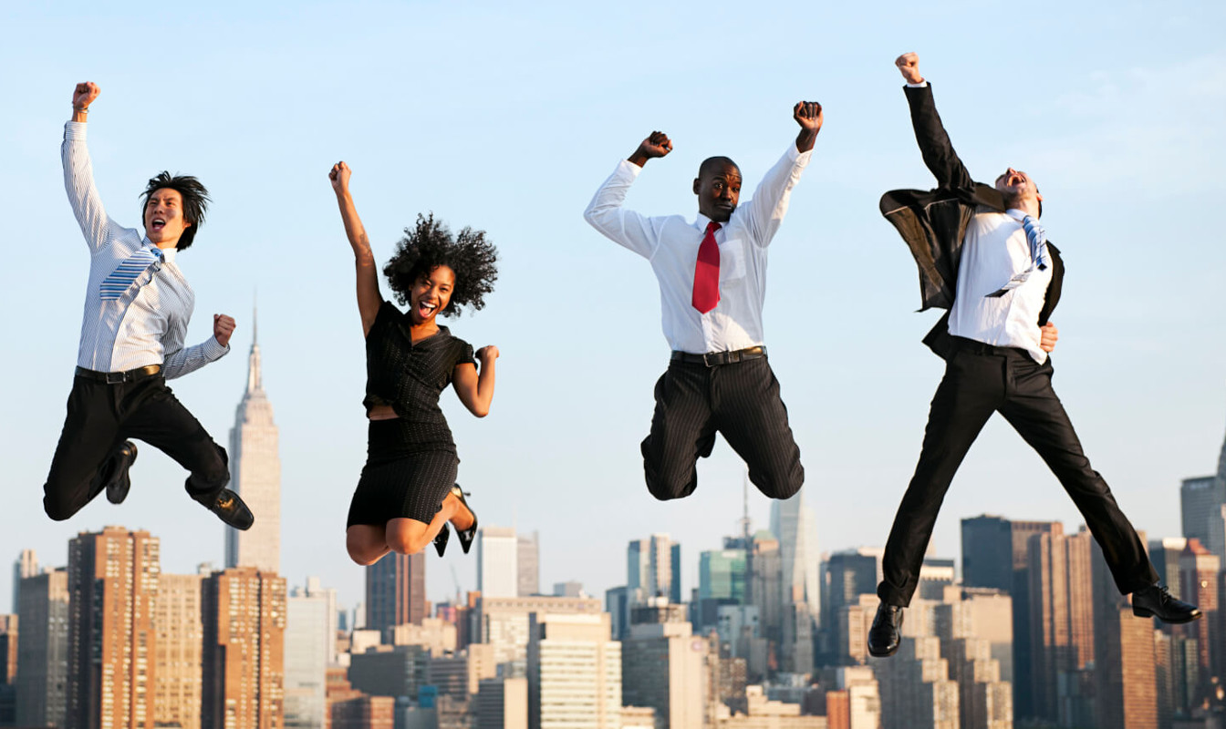 Employees jumping in the air cheering