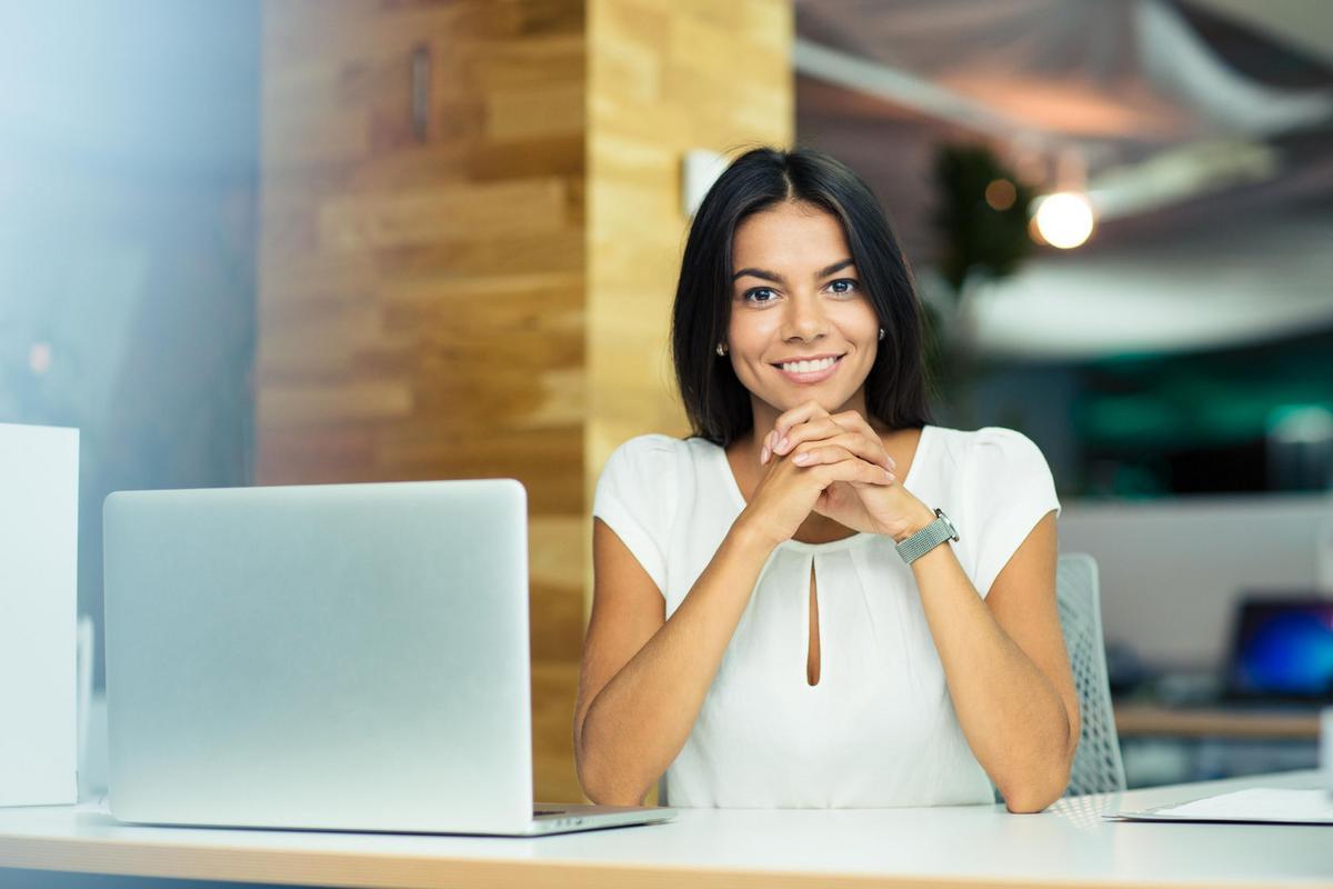 Smiling business woman sitting at a office desk