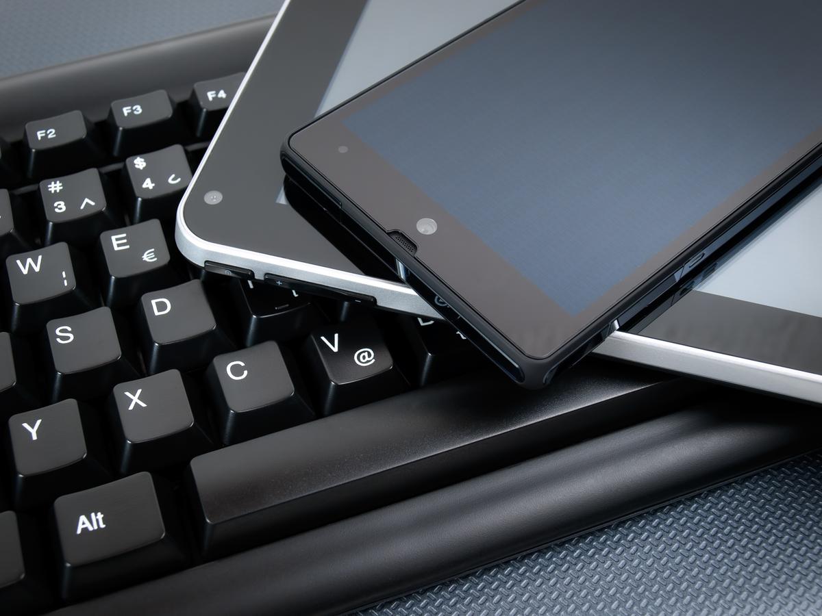 Laptop, tablet and mobile phone stacked