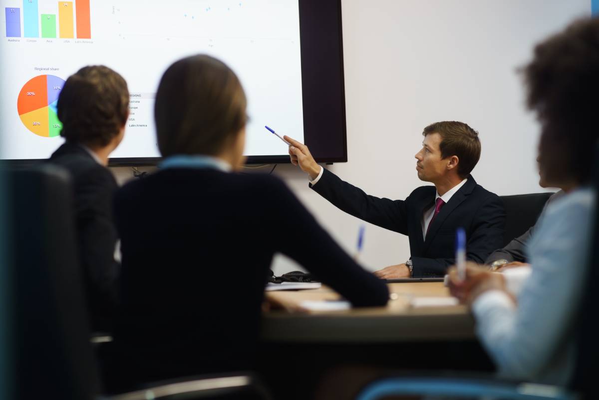 Business people in a meeting looking at growth charts.