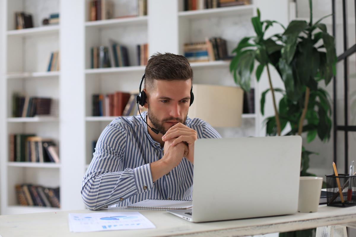 Man with headphones working on laptop