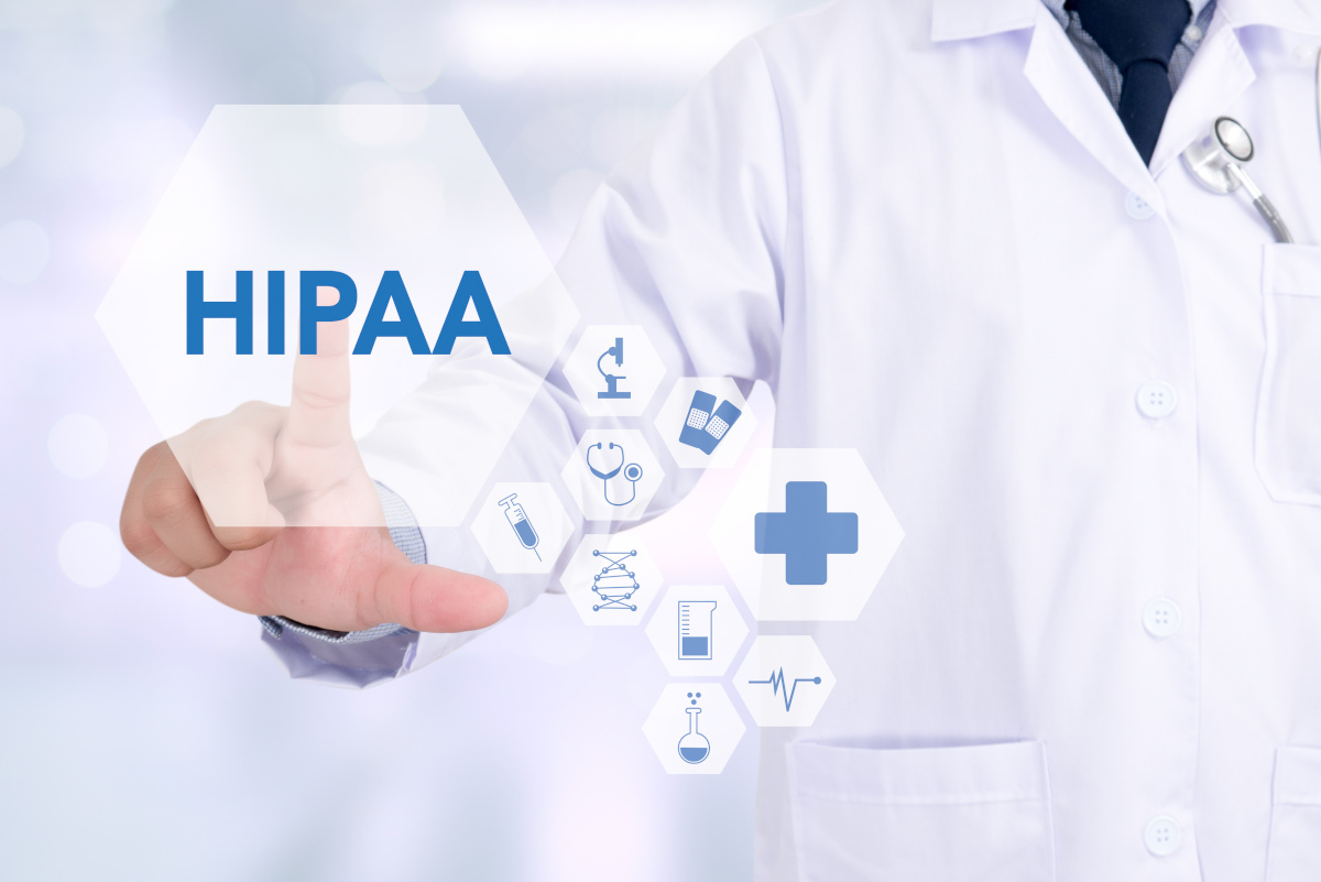 A doctor reaching out and pressing on a hexagon that displays the word HIPAA in the foreground that is connected to other hexagons with symbols related to healthcare