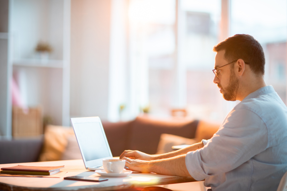 Man with Beard Using Laptop Computer at Home, Remote Staff/Work from Home Concept