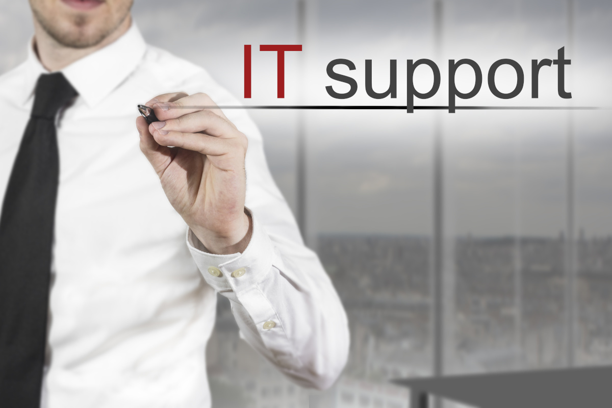 A person with a tie and button up shirt underlining the words IT Support