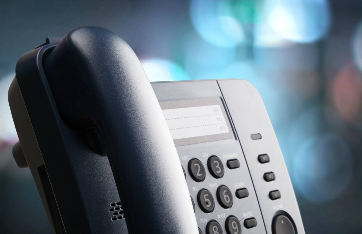 A close up view of a business phone on a blue background