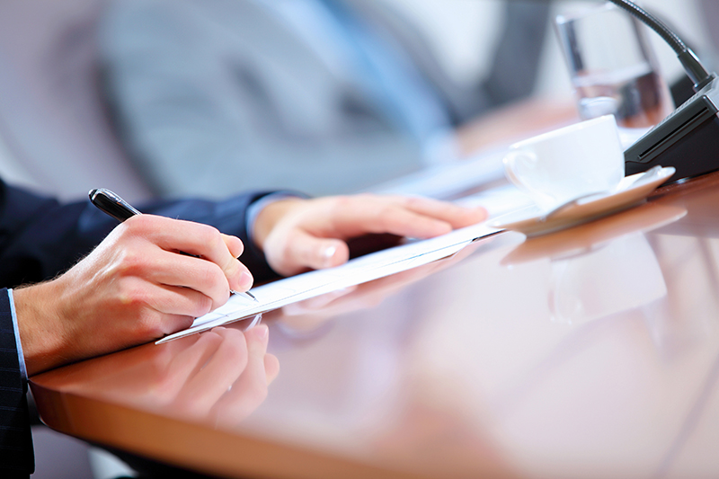 Writing on Paper at a Table