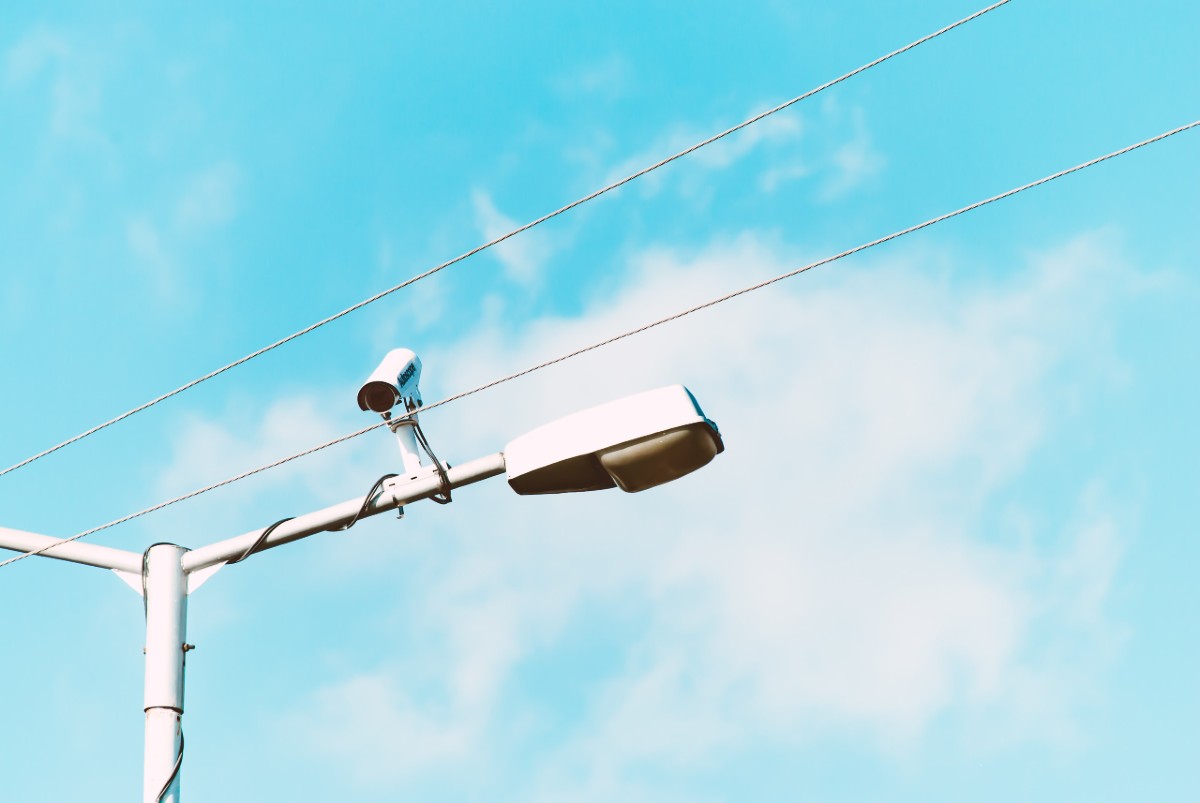 Close-up Photo of White Lamp Post and Camera