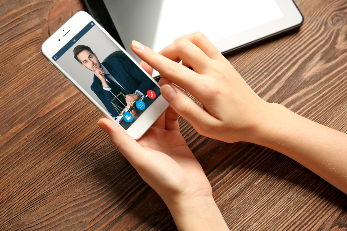 A woman using her cellphone to video conference with a businessman