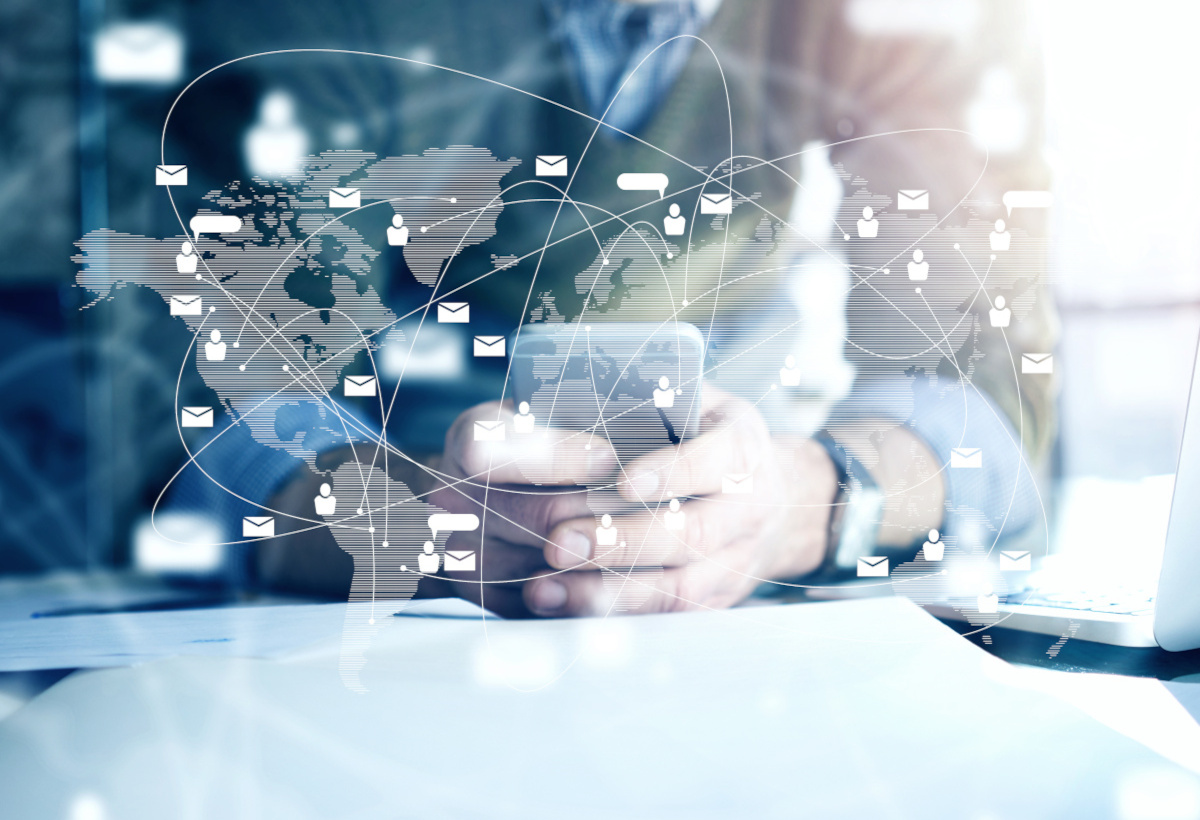 Man using mobile phone with digital representation of global network