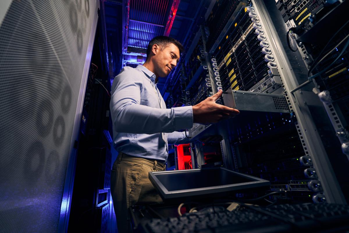 Man working in server room.
