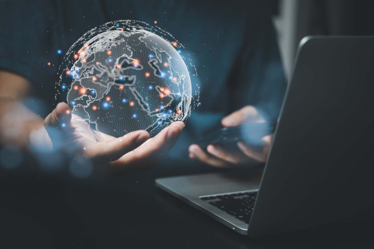 Man holding tablet and digital world globe