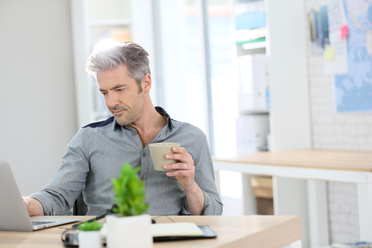Relaxed man working on laptop