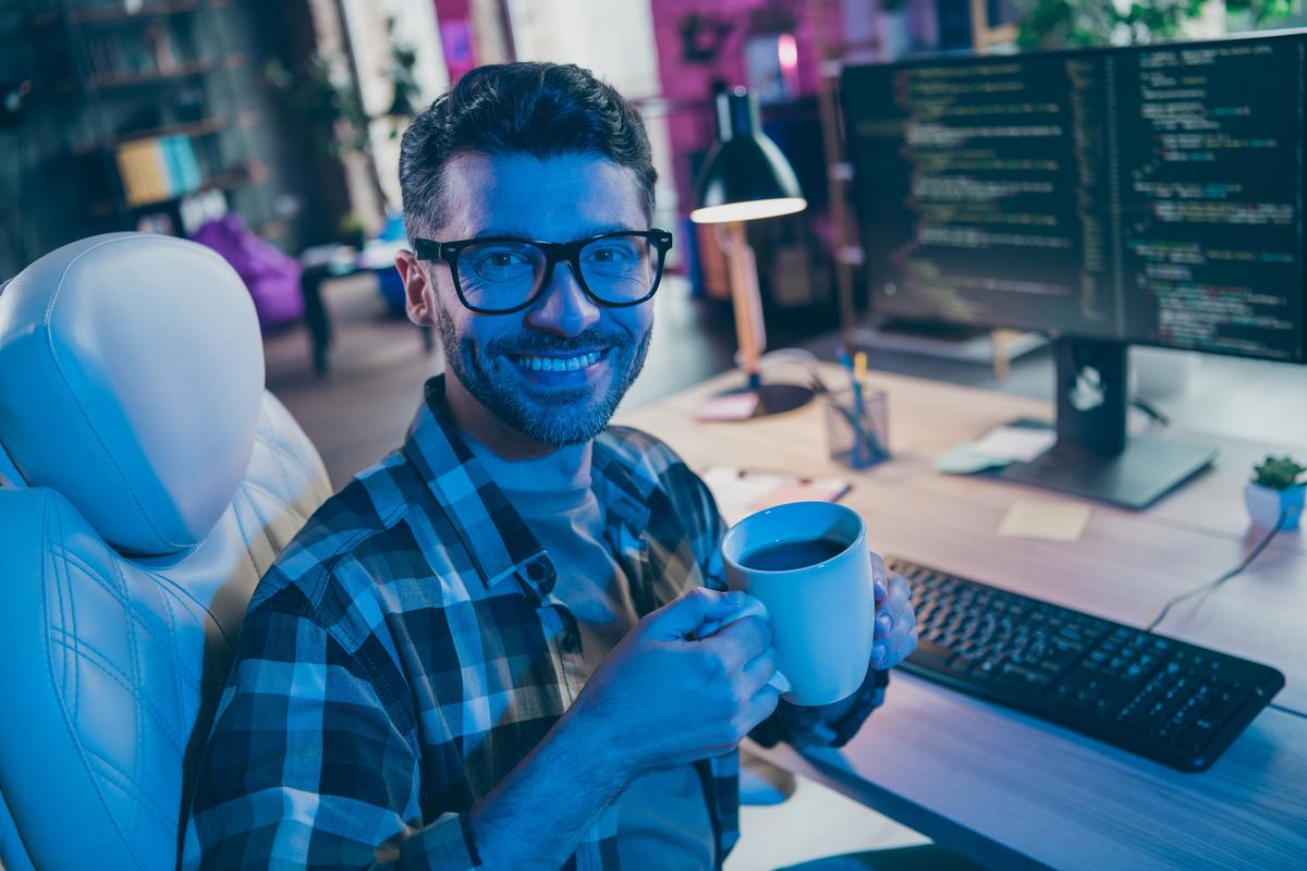 Smiling programmer working in an office.
