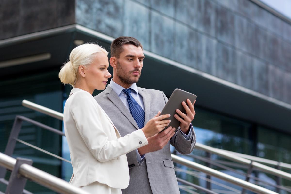 Man and woman looking at a tablet